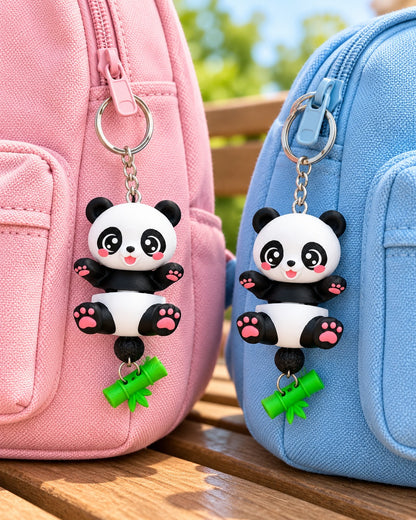 Two matching panda keychains on pink and blue backpacks