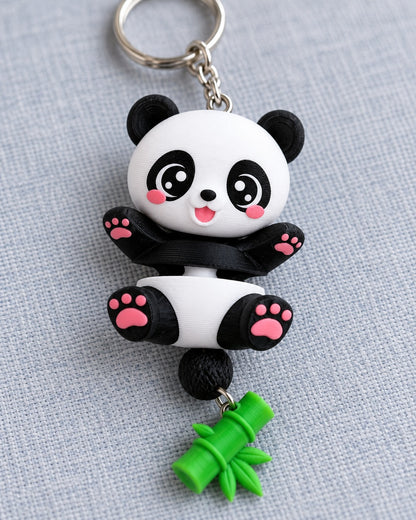 Close-up of the 3D printed panda keychain face and pink paw pads